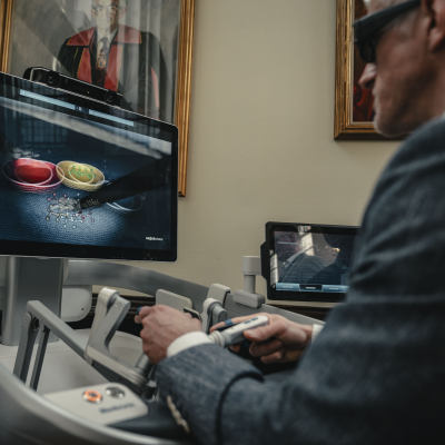 Someone practising with a surgical robot